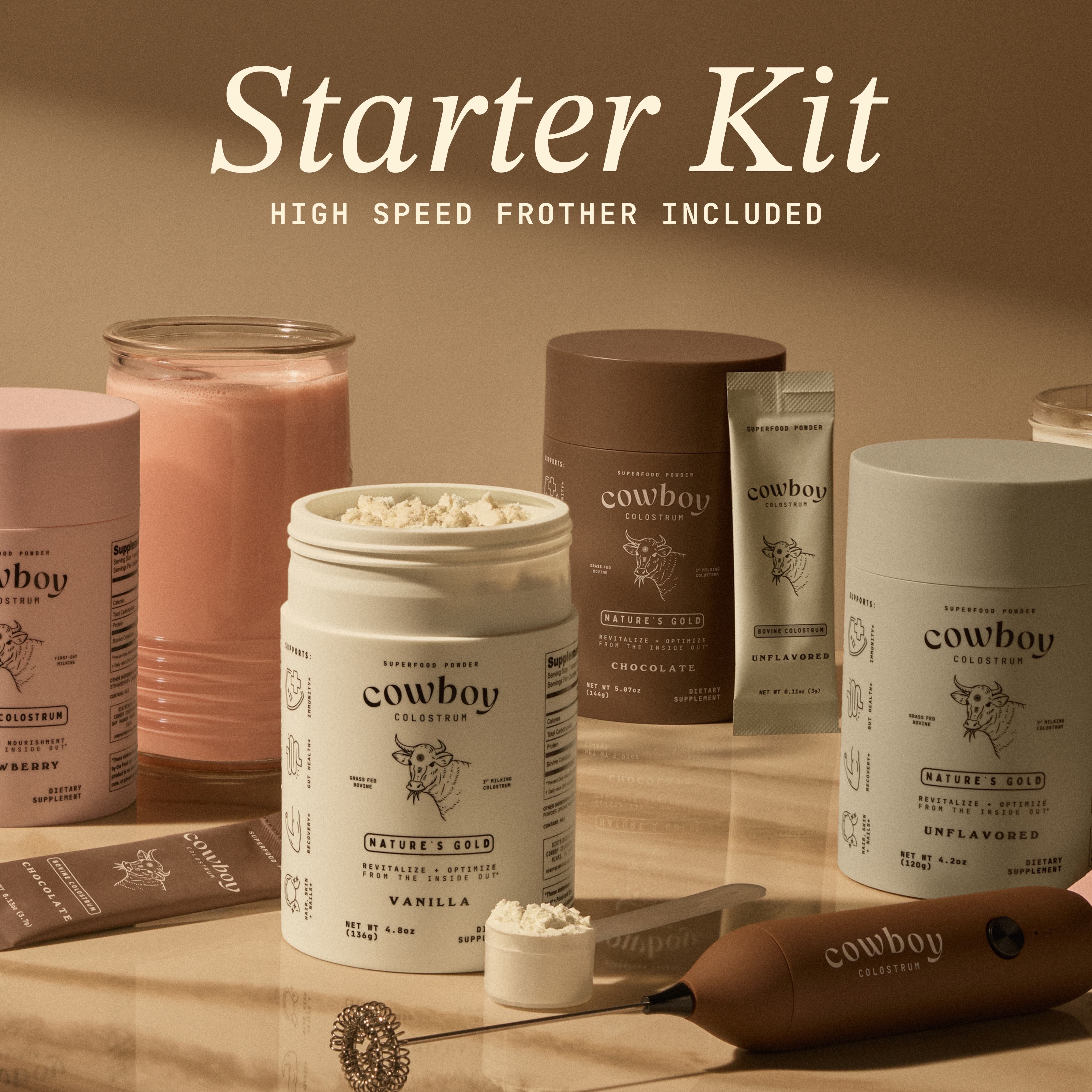 Starter Kit product bundle on cream background showing colostrum bottles, stick packs, a frother, and a glass with a strawberry colostrum beverage. Text reads: Starter Kit - High Speed Frother Incuded.